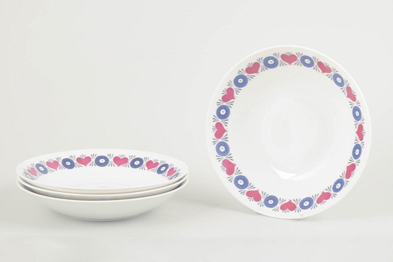 Marianne Westman for Rorstrand, Sweden. Set of four stoneware soup plates with floral motif. Approx.: Marianne Westman for Rorstrand. Set of 4 soup plates, Silja model, 1960s. Decorated with Westman's signature retro floral motif in blue and pink on a white ground. Part of Rorstrand's "El-Fast"