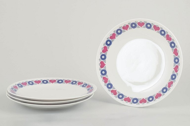 Marianne Westman for Rorstrand, Sweden. Set of four stoneware dinner plates with floral motif.: Marianne Westman for Rorstrand. Set of 4 dinner plates, Silja model, 1960s. Decorated with Westman's iconic retro floral motif in blue and pink on a white ground. Part of Rorstrand's "El-Fast" series