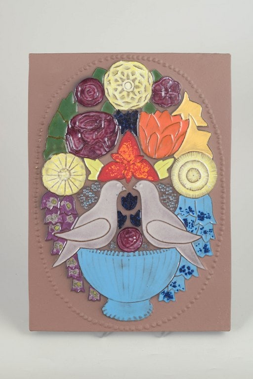 Sven-Erik Skawonius for Upsala Ekeby, Sweden. Colourful ceramic wall relief with floral and bird: Upsala Ekeby, wall relief by Sven-Erik Skawonius. Colourful ceramic wall relief depicting a stylised floral arrangement with two birds in raised relief. Constructed as a composite tile-like decoration