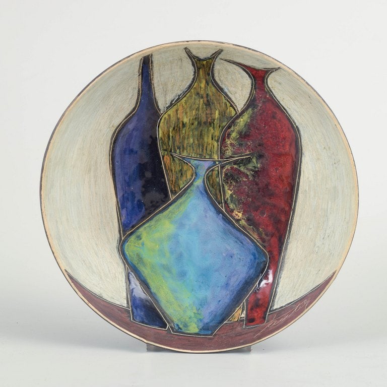 Marcello Fantoni, Italy. Low, circular ceramic bowl with an abstract relief composition. Approx.: Marcello Fantoni, unique bowl. Low, circular ceramic bowl with an abstract relief composition in deep blue, green, and red tones set against a light ground. The design reflects a strong modernist aest