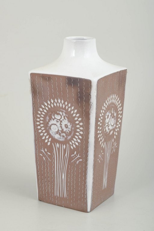 Mari Simmulson for Upsala Ekeby, Sweden. Faceted glazed ceramic vase with a square body and short: Mari Simmulson for Upsala Ekeby, vase. Faceted glazed ceramic vase with a square body and short neck. Decorated with stylised floral and radiating motifs in white against a brown ground glaze, execute