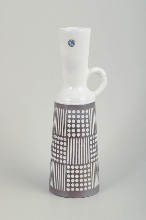 Mari Simmulson for Upsala Ekeby, Sweden. Tall ceramic pitcher with a narrow neck and single handle.: Mari Simmulson for Upsala Ekeby, pitcher. Tall, slender glazed ceramic pitcher with a narrow neck and single handle. The lower section is decorated with a strict graphic pattern of dots and vertical l