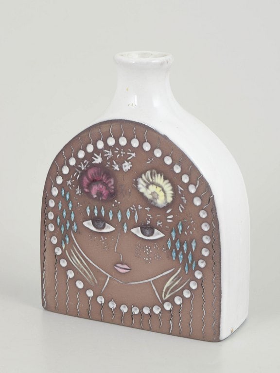 Mari Simmulson for Upsala Ekeby, Sweden. Figurative faience vase with female portrait. Approx.: Mari Simmulson for Upsala Ekeby, vase. Figurative vase with a stylised female portrait decorated with flowers and geometric ornaments in relief and coloured glaze. Origin: Sweden. Designer: Mari