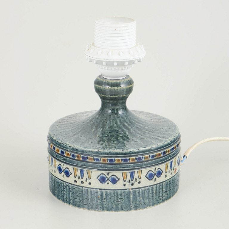 Yngve Blixt for Hoganas, Sweden. Small stoneware table lamp in blue, yellow and brown tones on: Yngve Blixt for Hoganas, table lamp. Handmade small table lamp in glazed stoneware with a baluster-shaped neck and broad, low base. Decorated with a band of geometric motifs in blue, yellow and brown 
