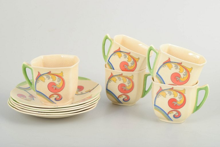 Clarice Cliff for Royal Doulton, England. Faience set of five coffee cups with saucers with: Clarice Cliff for Royal Doulton, set of 5 coffee cups with saucers. Art Deco faience coffee set with a craquelure glaze and decoration from the "Syren" series. The cups have a classic, subtly conical 