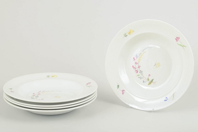 Stig Lindberg for Gustavsberg, Sweden. Set of five faience soup plates with floral decoration.: Stig Lindberg for Gustavsberg Set of five soup plates, "Haga" series, mid-20th century. Set of five deep plates in white faience with hand-painted floral decoration in soft pastel tones, designed by