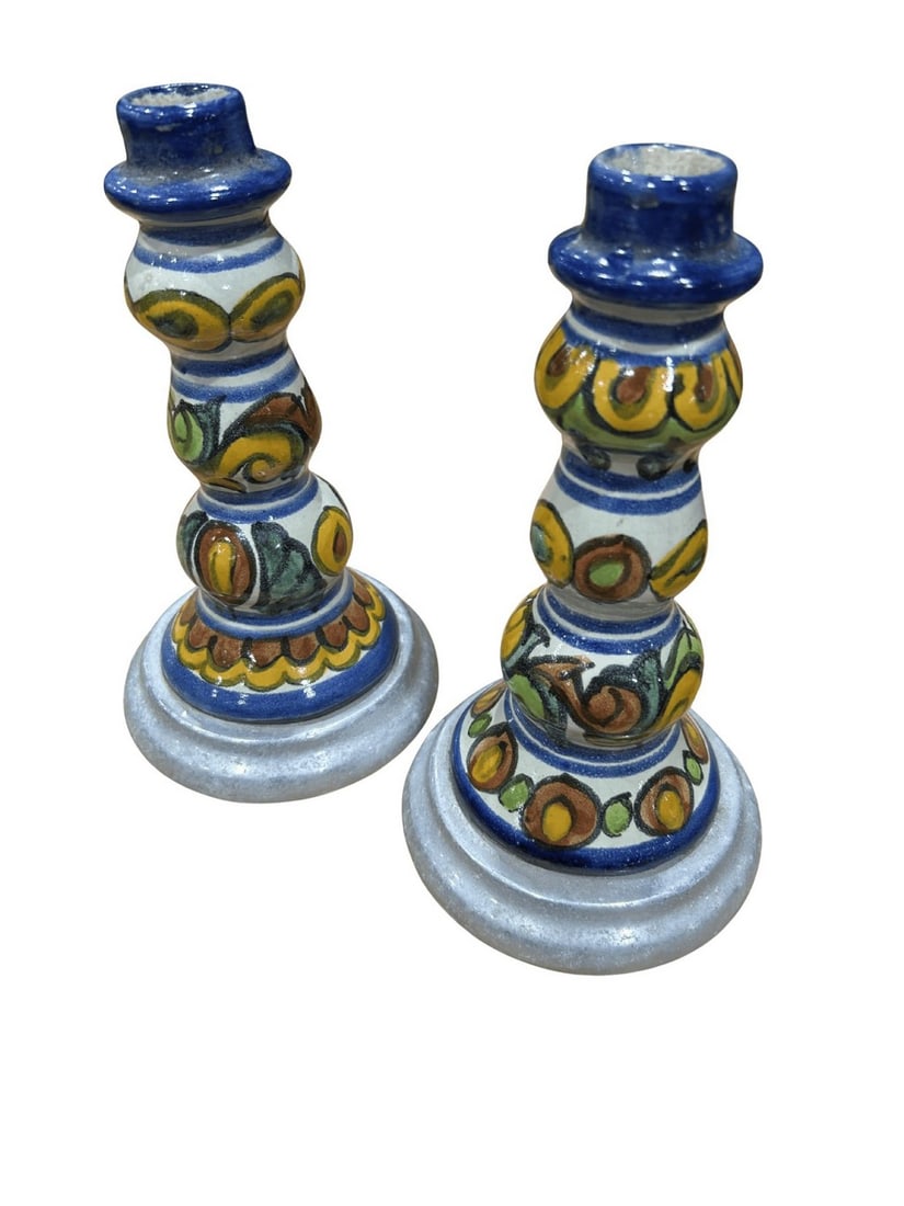 Pair of Talavera-Style Ceramic Candlestick Holders: A charming pair of Talavera-style ceramic candlestick holders, likely of Mexican origin, featuring intricate hand-painted designs. Each holder showcases a vibrant palette of blue, yellow, green, and