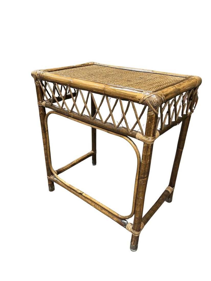 Vintage Rattan and Woven Cane Side Table: A charming vintage side table crafted from natural rattan and featuring a tightly woven cane top. The table showcases a classic bamboo-style frame with cross-hatch detailing on the sides, indicative o