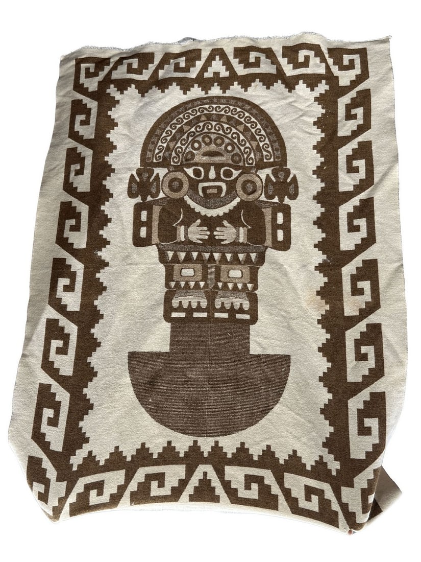 Peruvian Alpaca Wool Blanket with Pre-Columbian Inspired Design: This contemporary Peruvian alpaca wool blanket features a striking design inspired by Pre-Columbian iconography, possibly depicting a deity or a ceremonial figure. The central motif is rendered in ric
