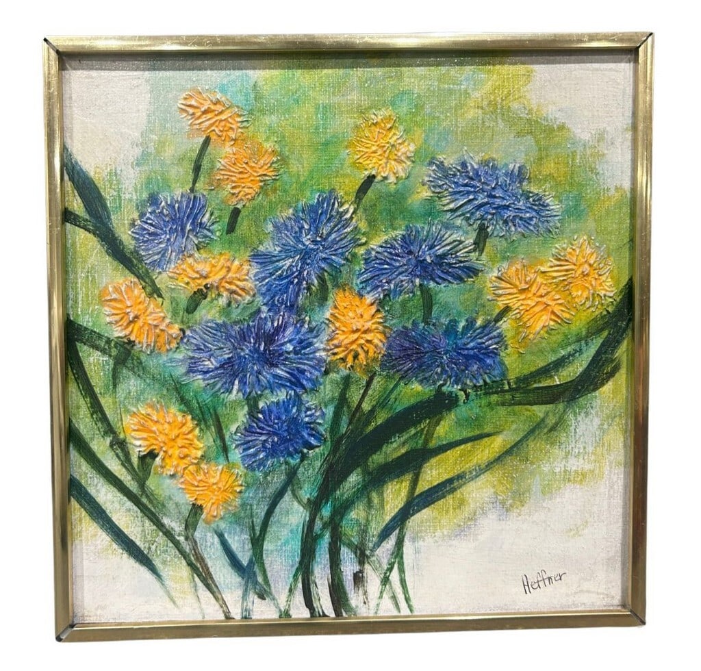 Mid-Century Modern Floral Impasto Painting by Heffner: This vibrant mid-century modern impasto painting, signed "Heffner," features a lively floral arrangement with prominent blue and orange blossoms. The heavy application of paint creates a tactile,