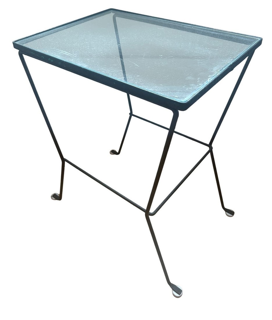 Mid-Century Modern Wrought Iron and Glass Side Table: This mid-20th century side table features a sleek, minimalist design, characteristic of the mid-century modern aesthetic. The table is constructed with a wrought iron frame, painted black, supporting