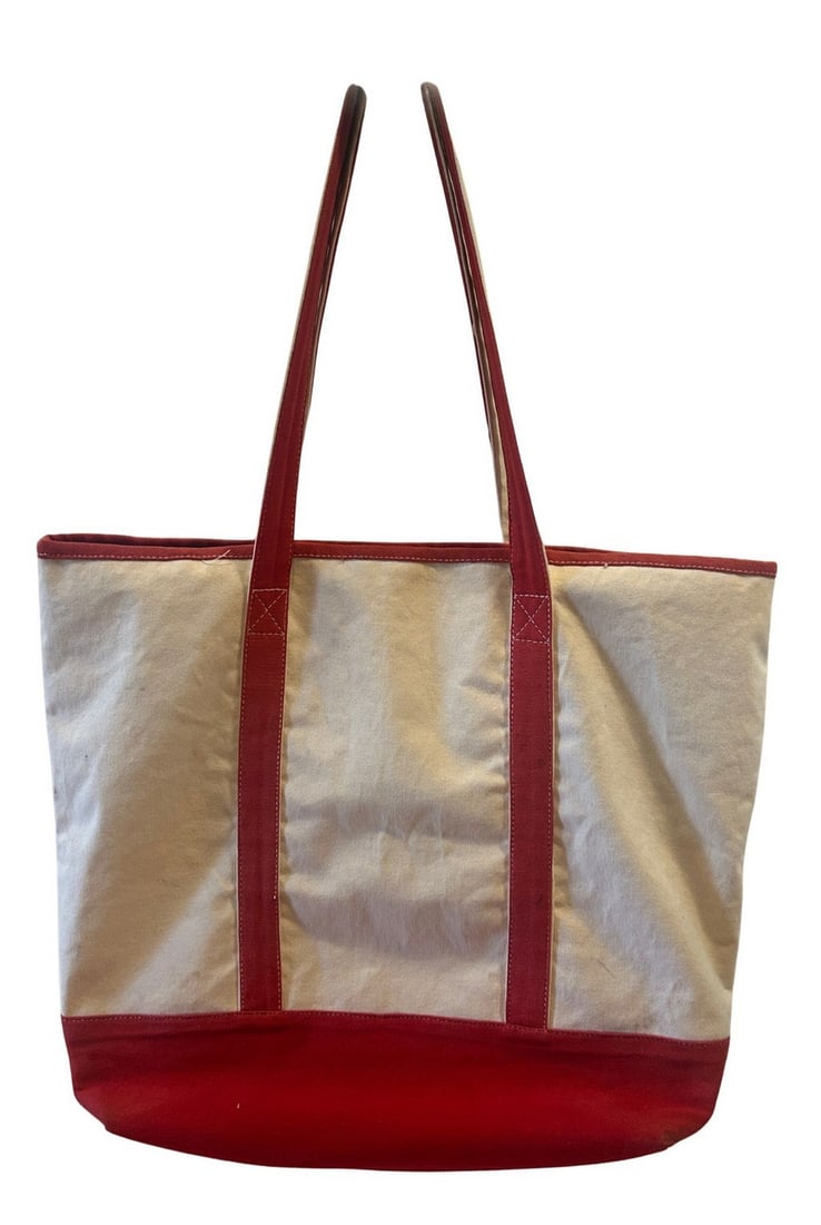 Vintage Red and Cream Canvas Tote Bag: A classic tote bag featuring durable cream-colored canvas with a vibrant red canvas base and trim. The bag includes sturdy red canvas handles and an exterior slip pocket (see condition). The interior