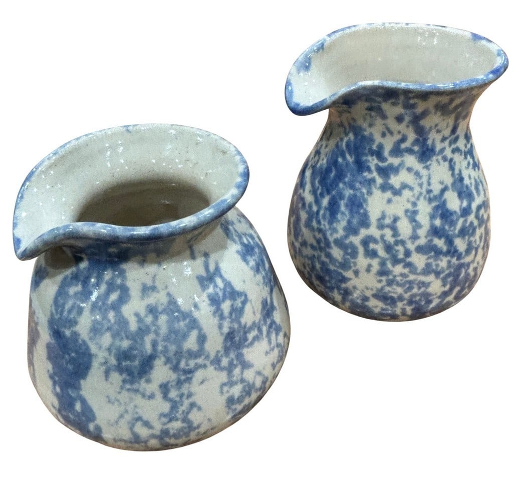 Pair of 1980s Vermont Studio Pottery Creamers: A charming pair of Vermont studio pottery creamers by Marion Waldo, dated 1988. Each creamer features a speckled blue and white glaze, commonly referred to as "spatterware" or "sponge ware," with a