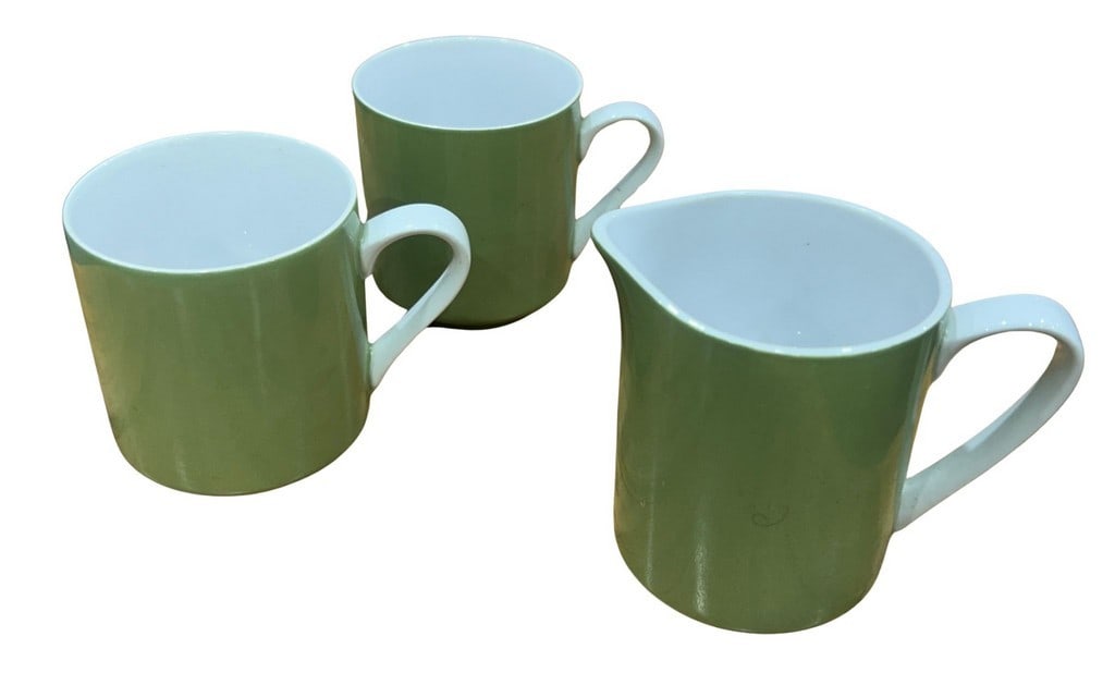 Set of Three Mikasa â€œFocus Shapeâ€? Sage Green Mugs with Creamer/Pitche: This lot features three Mikasa "Focus Shape" mugs and one matching creamer/pitcher in a charming sage green glaze with white interiors and handles. The sleek, minimalist design is characteristic of