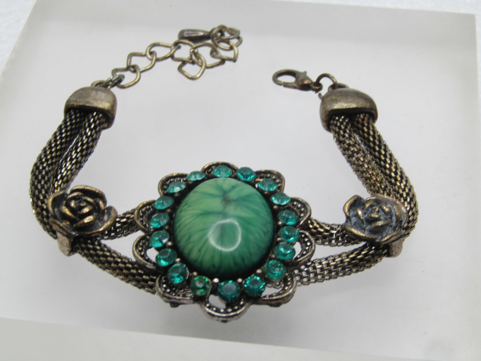 Vintage Green Rhinestone, Mesh, Rose Bracelet, 8-9", 1980's: Title: Vintage Green Rhinestone, Mesh, Rose Bracelet, 8-9", 1980's Description: Vintage Green Rhinestone, Mesh, Rose Bracelet,78-9", 1980's. This has a center scalloped large green acrylic cabochon