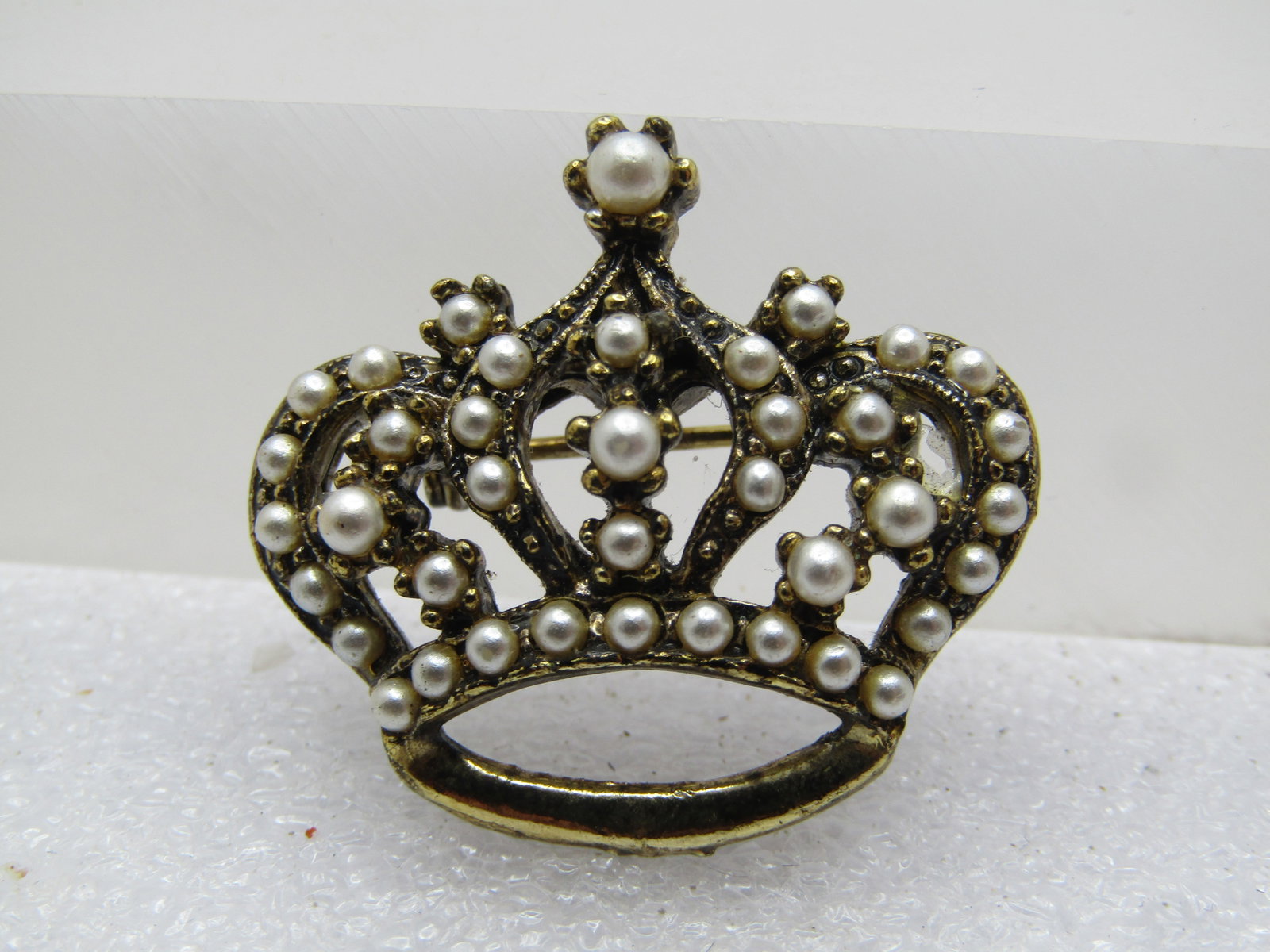 Vintage Faux Pearl Crown Brooch, 1960's-1970's: Title: Vintage Faux Pearl Crown Brooch, 1960's-1970's Description: Vintage Faux Pearl Crown Brooch, 1960's-1970's. Gold tone and 1.25" wide and 1" tall with faux seed pears throughout the crown and a 