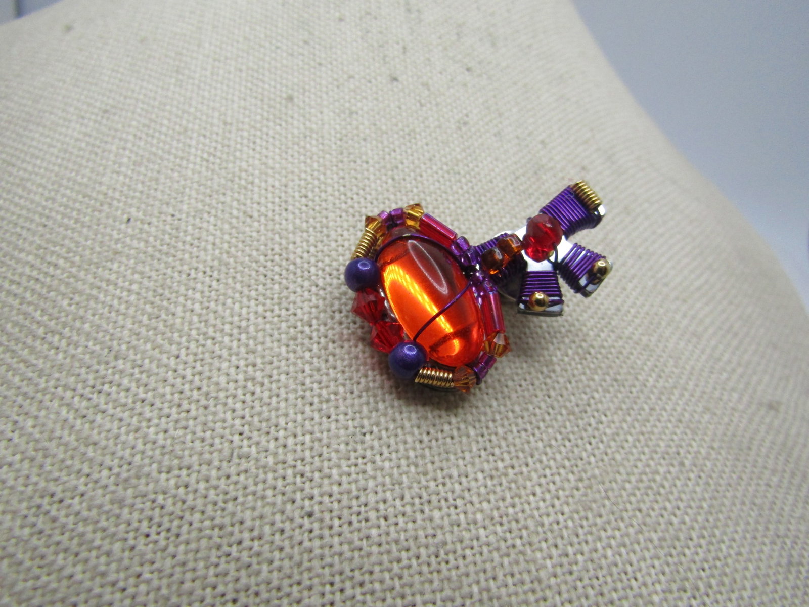 Liztech Mod Key Tack Pin, Orange/Purple/Red: Title: Liztech Mod Key Tack Pin, Orange/Purple/Red Description: Liztech Mod Key Tack Pin, Orange/Purple/Red. this has purpled wrapped thread with a large orange cabochon, purple iridescent beads and r