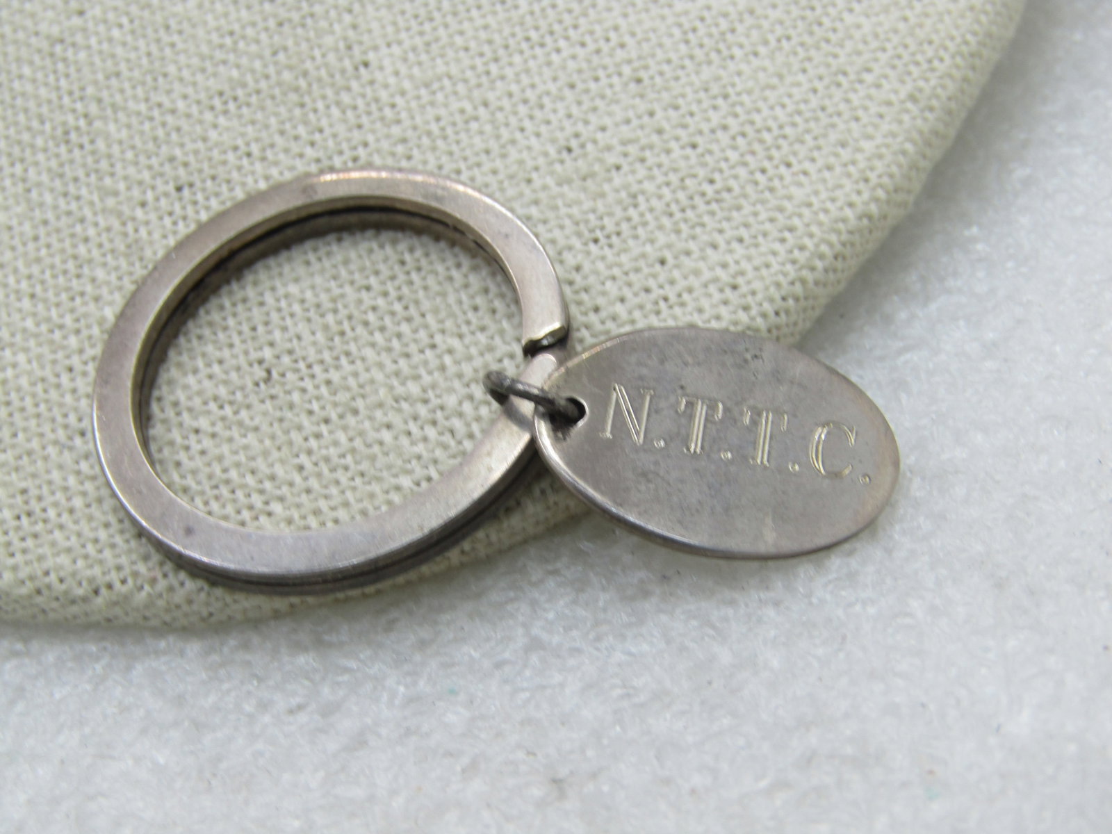 Vintage 1973 Tiffany & Co. Engraved Key Ring, N.T.T.C.: Title: Vintage 1973 Tiffany & Co. Engraved Key Ring, N.T.T.C. Description: Vintage 1973 Tiffany & Co. Engraved Key Ring, N.T.T.C., 10.23 gr. Oval 1" ring engraved N.T.T.C. on one side and 1973 on the
