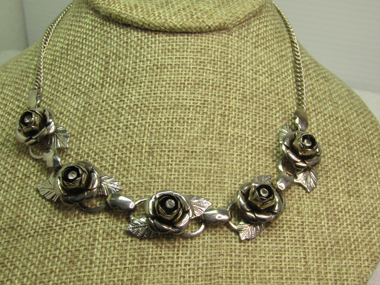 Vintage Rose Blossom Necklace, Rhinestone Center, 16.5", 1960's-1970's: Title: Vintage Rose Blossom Necklace, Rhinestone Center, 16.5", 1960's-1970's Description: Vintage Rose Blossom Necklace, Rhinestone Center, 16.5", 1960's-1970's. Silver tone with the front having fiv