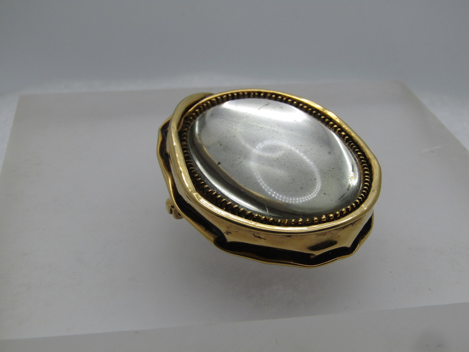 Vintage Looking Glass Brooch, 1980's, Mod/Abstract, 2": Title: Vintage Looking Glass Brooch, 1980's, Mod/Abstract, 2" Description: Vintage Looking Glass Brooch, 1980's, Mod/Abstract, 2" by 1.5". It has a clear large oval acrylic domed stone cabochon that i