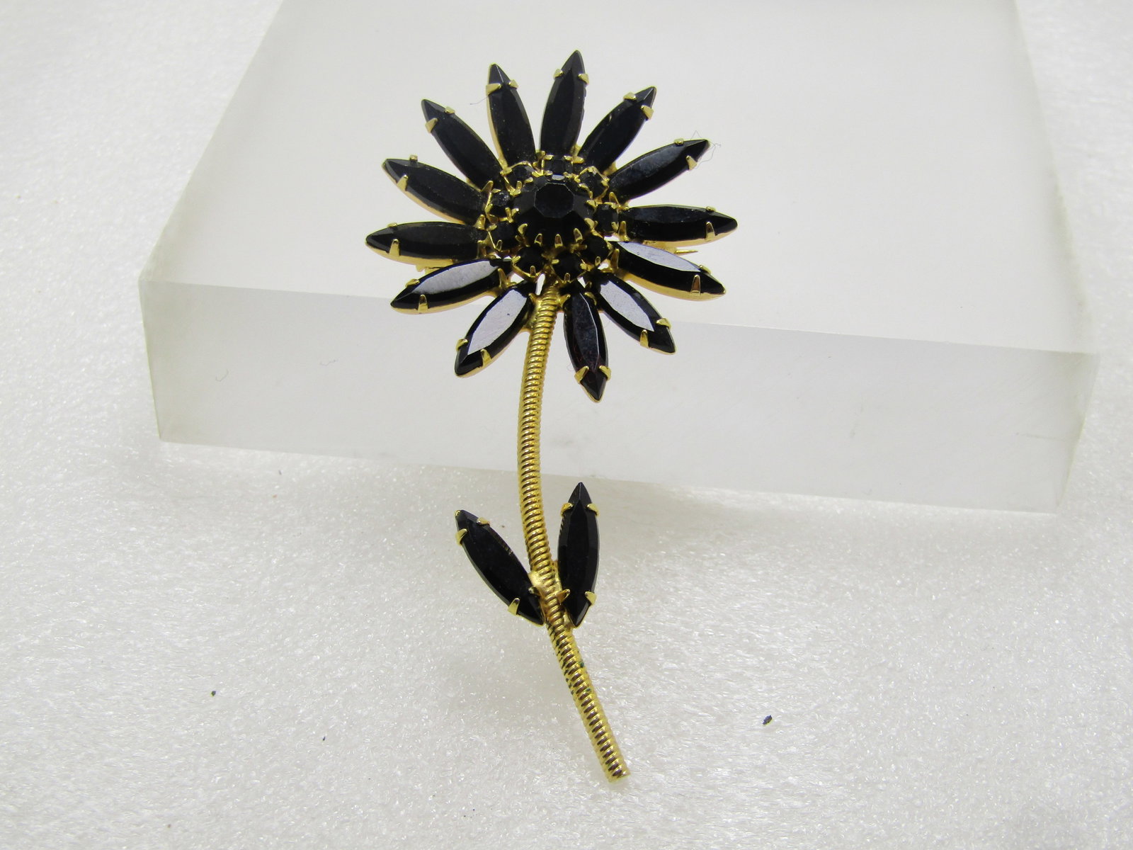 Vintage Rhinestone Floral Stem Brooch, Black Glass, 1960's: Title: Vintage Rhinestone Floral Stem Brooch, Black Glass, 1960's Description: Vintage Rhinestone Floral Stem Brooch, Black Glass, 1960's. It is appx. 3" tall and 1.5" wide. Gold tone twisted look ste