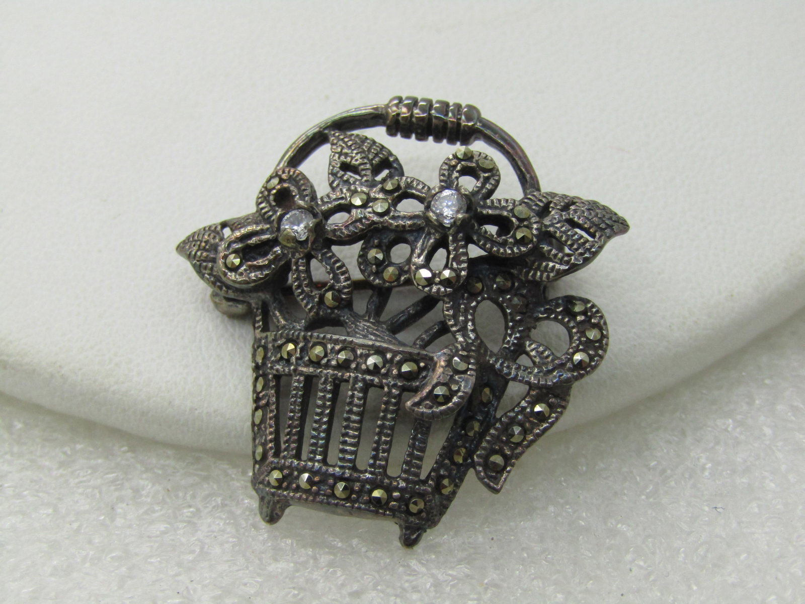 Vintage Sterling Marcasite Flower Basket Brooch, Signed M: Title: Vintage Sterling Marcasite Flower Basket Brooch, Signed M Description: Vintage Sterling Marcasite Flower Basket Brooch, Signed M, 7.64 grams. Appx. 1.25" tall and wide. Intricate design of an o