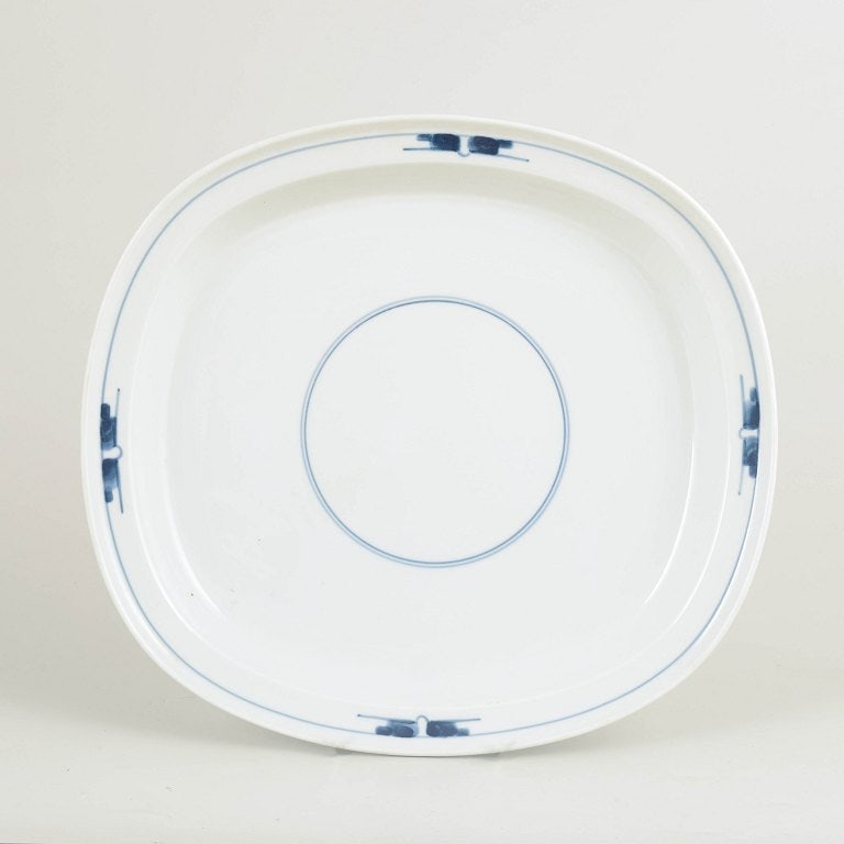 Gertrud Vasegaard for Royal Copenhagen, Denmark. Large porcelain serving platter with blue: Gertrud Vasegaard for Royal Copenhagen Gemina large serving platter, 1970s. Large serving platter from the Gemina service, produced in white porcelain with a subtle, graphic blue underglaze decoration