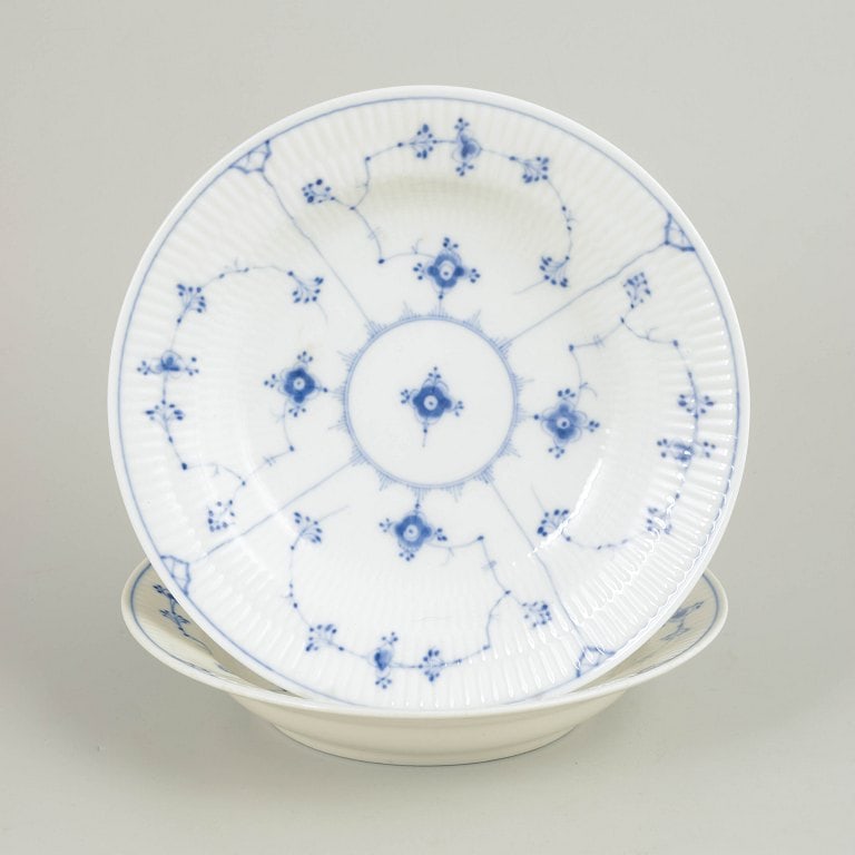 Bing & Grøndahl, Scandinavia. Blue Fluted, set of two porcelain deep plates decorated underglaze: Bing & Grøndahl, Blue Fluted deep plates, set of 2. Two deep porcelain plates with hand-painted Blue Fluted decoration executed in underglaze blue. The characteristic fluted body and the finely detai