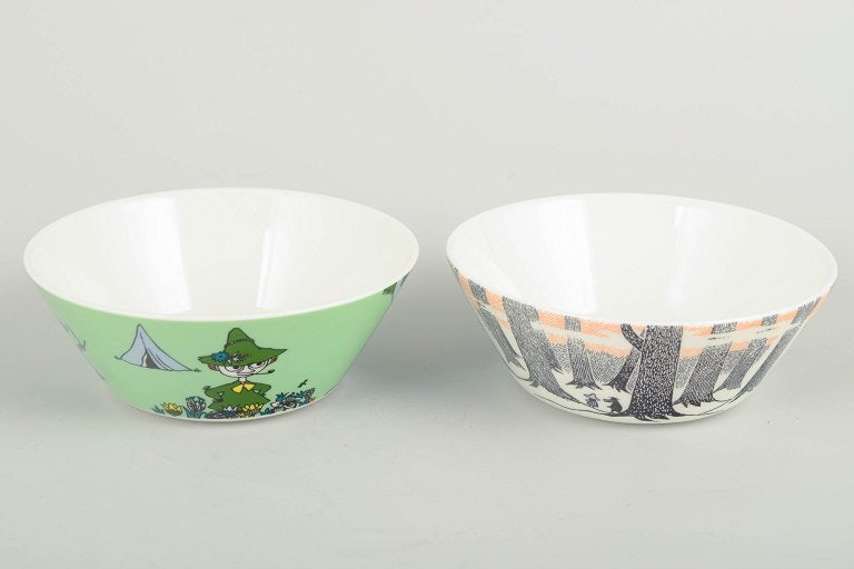 Arabia, Finland. Two porcelain Moomin bowls. 21st century.: Arabia Finland Moomin bowls, 21st century. Two decorative porcelain Moomin bowls by Arabia Finland. One bowl in light green with Snufkin and a tent motif; the other features a graphic forest design in