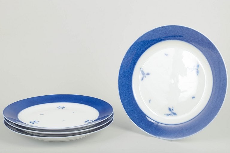 Royal Copenhagen, Denmark. Four large porcelain dinner plates with blue rim and floral accents. (1 of 4)