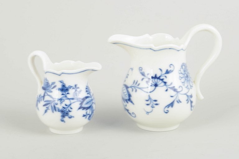 Meissen, Germany. Two porcelain creamers decorated with cobalt blue glaze, “Blue Onion??. Circa: Meissen Two creamers, “Blue Onion”, c. 1900. Two porcelain cream jugs in Meissen's classic “Zwiebelmuster” blue onion pattern, hand-painted in cobalt blue on white porcelain. Organic b