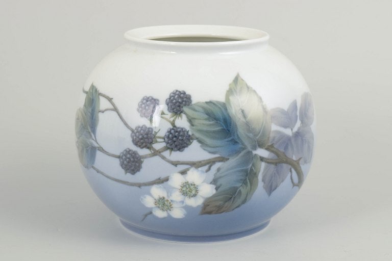 Royal Copenhagen, Denmark. Round baluster-shaped porcelain vase decorated with berry branches and: Royal Copenhagen, vase. Round, baluster-shaped glazed porcelain vase with hand-painted underglaze decoration of berry branches and foliage in muted blue, green, and grey tones on a light ground,