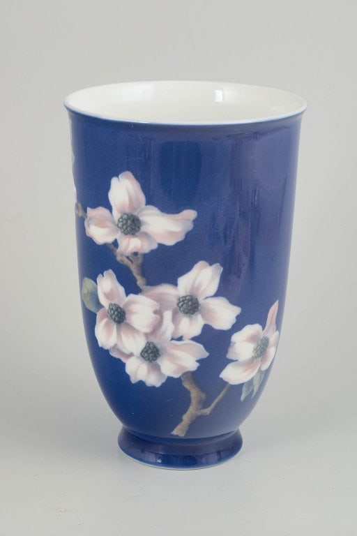 Royal Copenhagen, Denmark. Tall cylindrical porcelain vase with a cobalt blue ground. Dated 1963.: Royal Copenhagen, vase. Tall cylindrical porcelain vase with a deep cobalt blue ground and a hand-painted underglaze decoration of flowers in soft pink and white tones with subtle grey detailing. The 