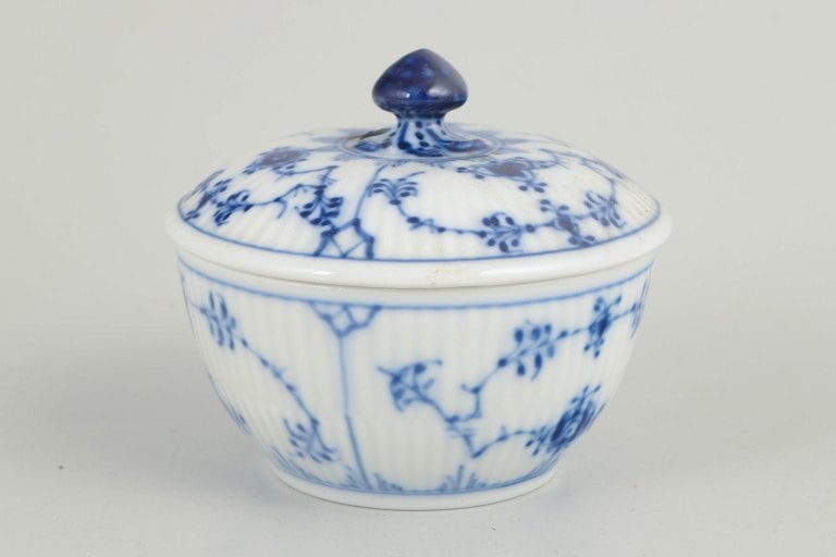 Royal Copenhagen, Denmark. Porcelain creamer decorated with cobalt-blue underglaze, Blue Fluted: Royal Copenhagen, sugar bowl, Blue Fluted Plain. Fluted sugar bowl in glazed porcelain with hand-painted cobalt-blue underglaze decoration. Classic rounded form with matching lid topped by a finial.