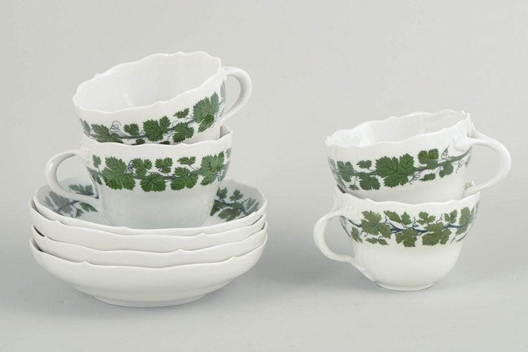 Meissen, Germany. Porcelain coffee set for four from the green vine leaf series. Early 20th century.: Meissen, coffee set for four from the green vine leaf series. Porcelain coffee set comprising four cups and four saucers with a green vine and vine-leaf border; from the green vine leaf series. Marked