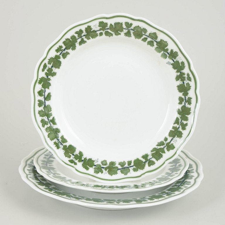 Meissen, Germany. Set of three porcelain plates from the green vine leaf series. Early 20th century.: Meissen, set of three plates from the green vine leaf series. Set of three porcelain plates with a green vine and vine-leaf border; from the green vine leaf series. Marked with the Meissen crossed