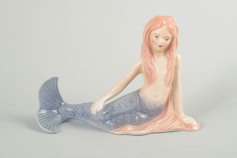 Bing & Grøndahl, Denmark. The Little Mermaid porcelain figurine. Late 20th century.: Bing & Grøndahl, The Little Mermaid figurine. Porcelain figurine depicting The Little Mermaid, produced for the H.C. Andersen Collection. The figure is modelled in a reclining pose with a finely deta