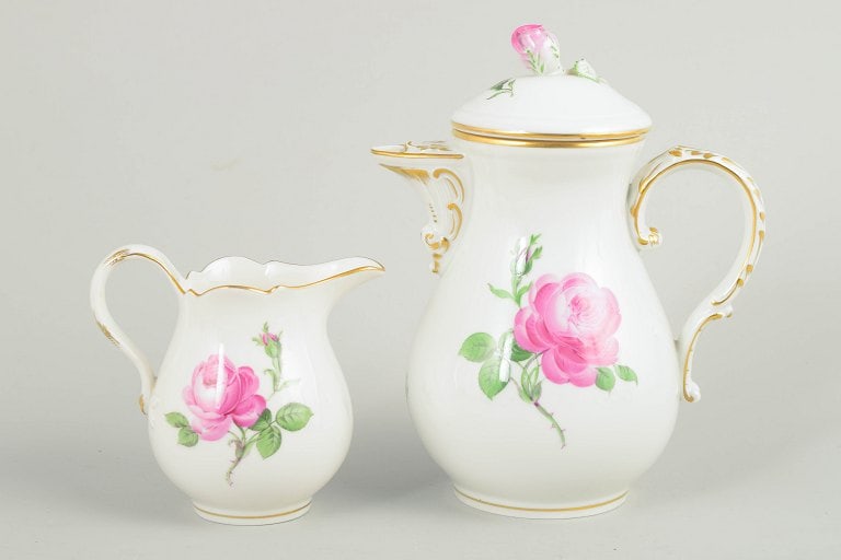 Meissen, Germany. Small porcelain coffee pot with lid and a creamer. Pink flower series. Circa 1900.: Meissen, small "pink flower" coffee pot with matching lid and a creamer. Set comprising a small lidded coffee pot and matching creamer in white porcelain with hand-painted pink roses and gilt accents.