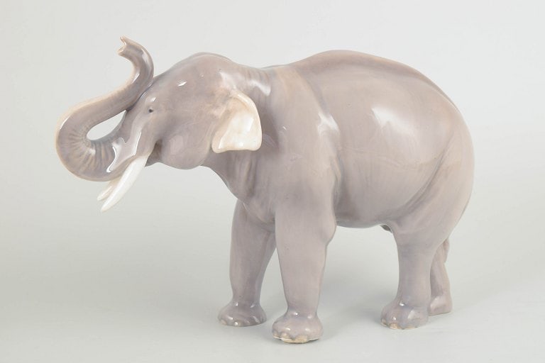 Royal Copenhagen, Denmark. Large porcelain African elephant figure with raised trunk. Approx. 1920s. (1 of 4)