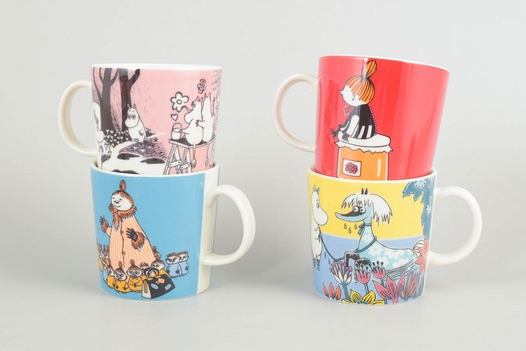 Arabia, Finland. Set of four porcelain Moomin mugs with colourful illustrations. 21st century. (1 of 4)
