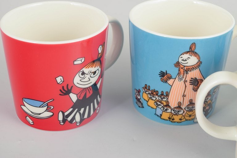 Arabia, Finland. Set of four porcelain Moomin mugs with colourful illustrations. 21st century. - 2