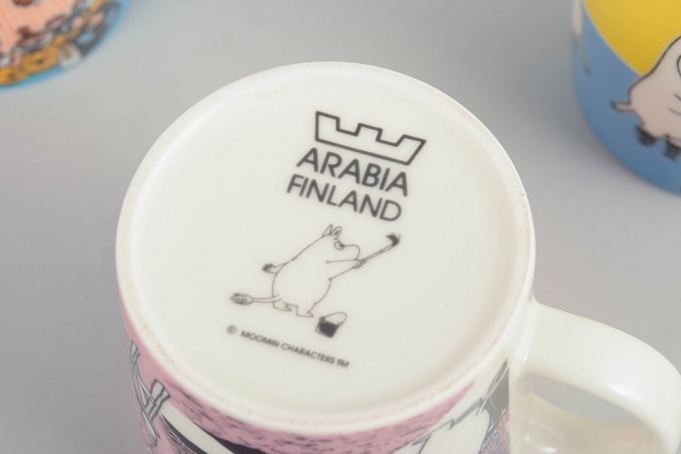 Arabia, Finland. Set of four porcelain Moomin mugs with colourful illustrations. 21st century. - 4