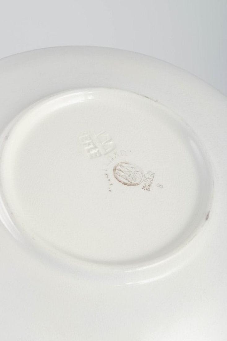 Gefle, Sweden. Set of twelve round 'Mullbär' faience plates with relief decoration. 1930s. - 4