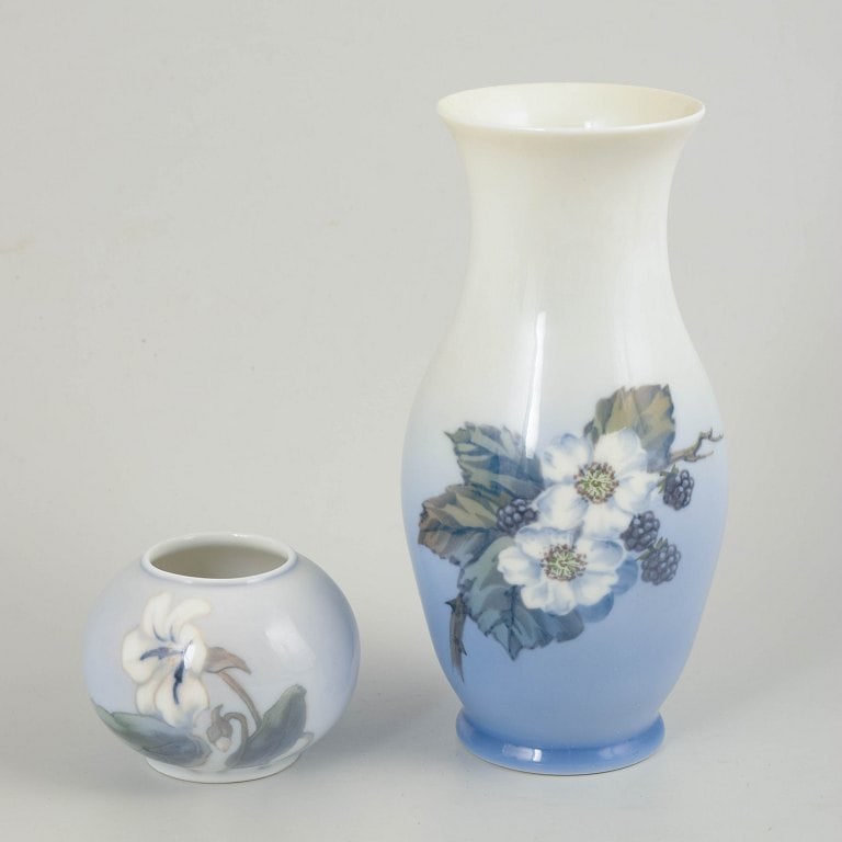 Royal Copenhagen, Denmark. Set of two porcelain vases with floral decoration in blue tone. 20th: Royal Copenhagen, vases, set of 2. Set comprising two vases in glazed porcelain with hand-painted underglaze decoration. The larger vase has a baluster form with floral decoration over a blue-toned