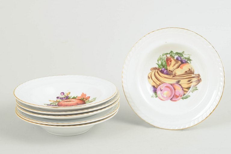 European porcelain maker. Set of six porcelain bowls decorated fruit motif and a gilt rim. Circa: European porcelain maker, set of 6 bowls. Set of six porcelain bowls decorated with a polychrome fruit motif and a gilt rim. Classic European tableware in a characteristic interwar style. Marked to th