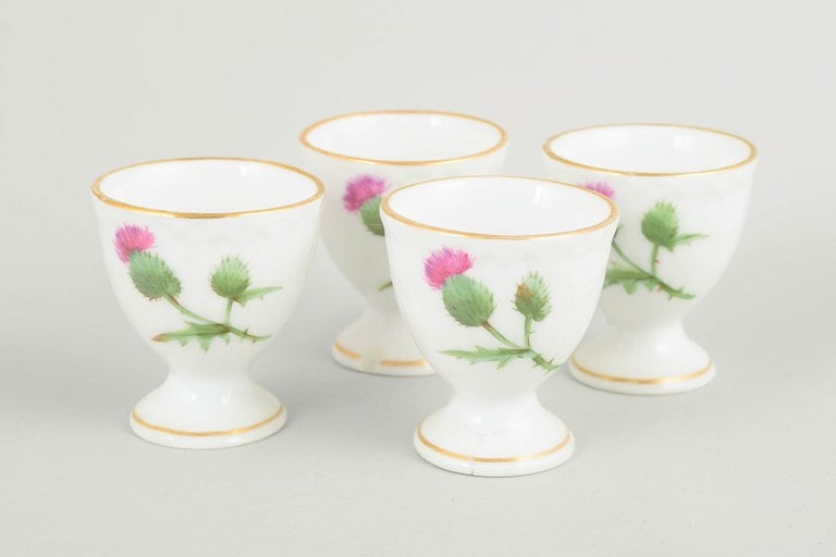 Royal Copenhagen, Denmark. Set of four porcelain egg cups with thistle motif. Second half of the (1 of 4)
