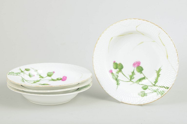 Royal Copenhagen, Denmark. Set of four porcelain deep pasta plates with thistle motif. Second half: Royal Copenhagen, set of 4 antique deep pasta plates. Hand-painted deep porcelain plates decorated with a naturalistic thistle motif and a gilded rim. The plates feature a subtly ribbed surface and