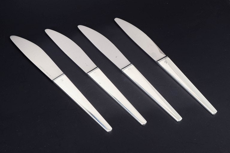 Henning Koppel for Georg Jensen, Denmark. Set of four dinner knives in stainless steel and sterling (1 of 5)