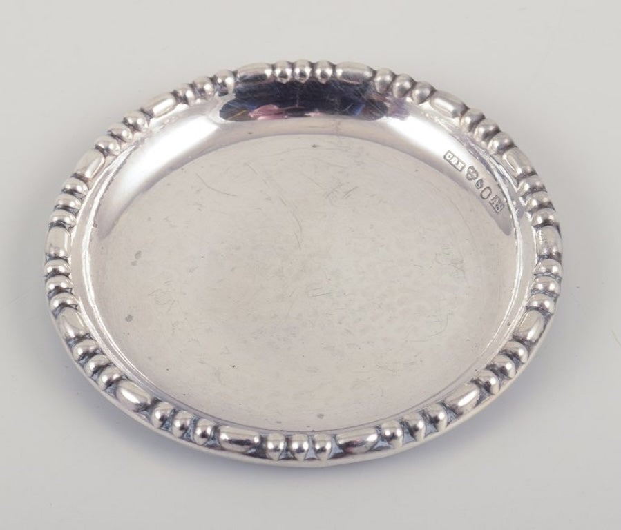 Hallberg, Stockholm. Royal Swedish Court Supplier. A set of twelve Art Deco glass coasters in 830 - 4