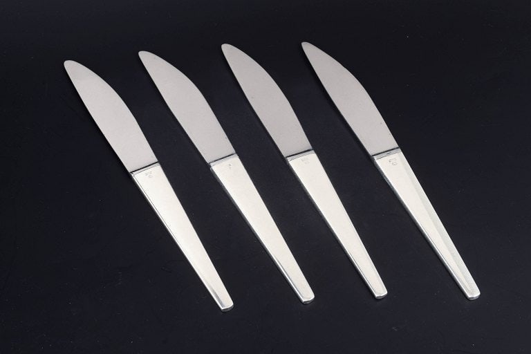 Henning Koppel for Georg Jensen, Denmark. Set of four dinner knives in stainless steel and sterling (1 of 4)